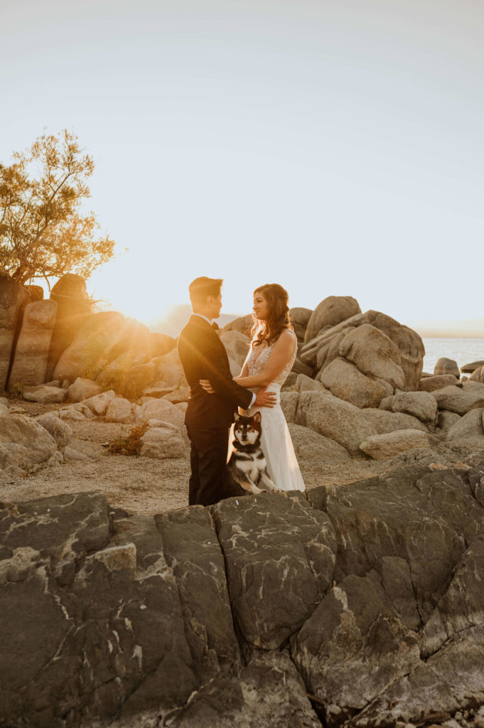 A couple in wedding attire at sunset in Lake Tahoe.
