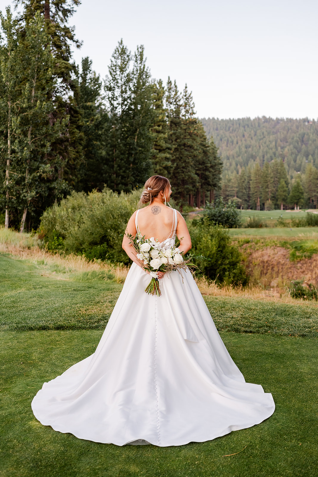 Romantic hand-edited sunset portraits of a bride and groom on the golf course pathways at a The Chateau at Incline Village wedding.
